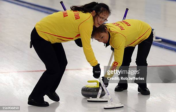 Qingshuang Yue and Yan Zhou of China in action during the Pacific Asia 2012 Curling Championship at the Naseby Indoor Curling Arena on November 25,...