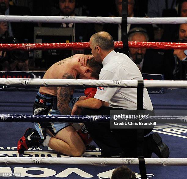 Ricky Hatton of Great Britain is consoled by the referee after being knocked out by Vyacheslav Senchenko of Ukraine during their welterweight bout at...