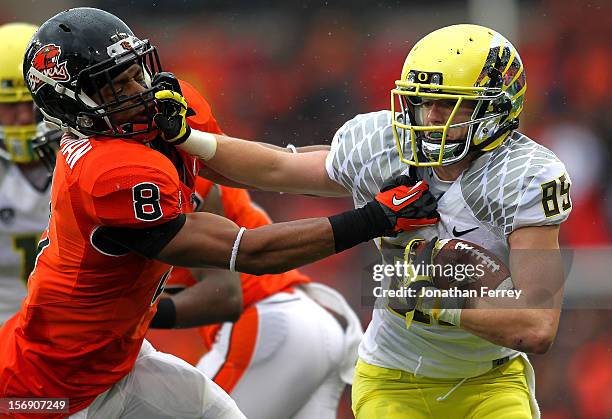 Will Murphy of the Oregon Ducks stif arms Tyrequek Zimmerman of the Oregon State Beavers during the 116th Civil War on November 24, 2012 at the Reser...