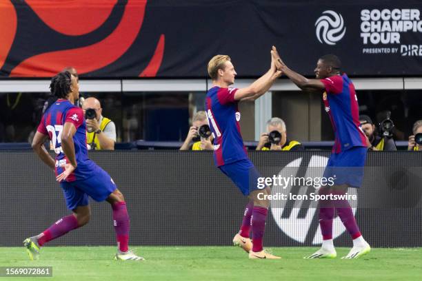 Barcelona midfielder Frenkie de Jong adn FC Barcelona forward Ousmane Dembele celebrate an early goal during the Soccer Champions Tour match between...