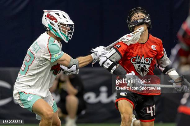 Whipsnakes defensive midfielder Jake Bernhardt gets his stick up high and into the helmet of Chaos midfielder Kyle Jackson during the Premier...