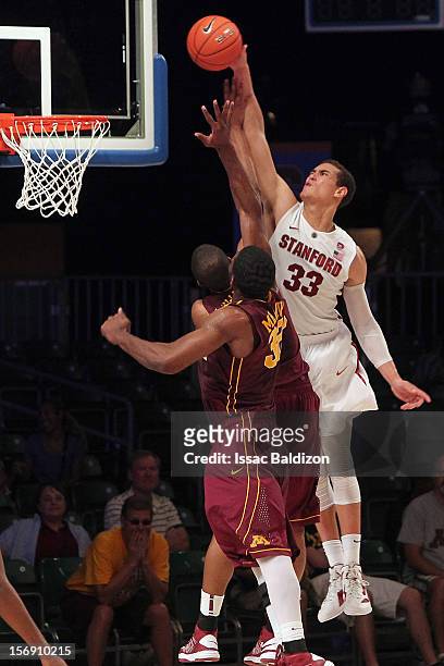 Dwight Powell of the Stanford Cardinal dunks over Rodney Williams of the Minnesota Gophers during the Battle 4 Atlantis tournament at Atlantis Resort...