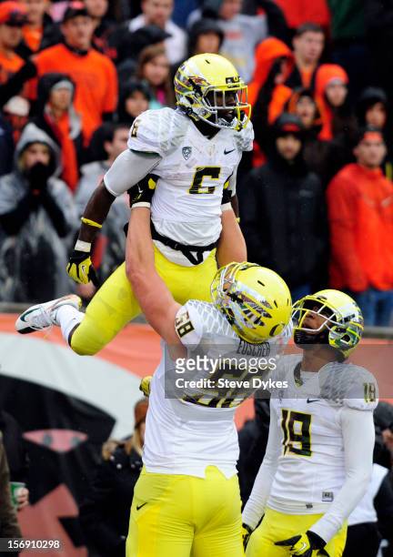 Running back De'Anthony Thomas is lifted into the air by offensive linesman James Euscher of the Oregon Ducks after scoring a touchdown as wide...