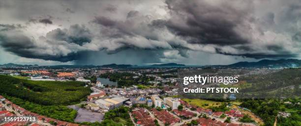 panorama a big rainstorm has swept over the mountainous phuket town and old phuket town, bringing heavy rain all day in phuket, thailand. - phuket old town stock-fotos und bilder