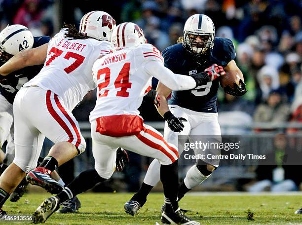 Wisconsin's Bryce Gilbert and Shelton Johnson try to stop Penn State's Michael Zordich on Saturday, November 24 at Beaver Stadium in University Park,...