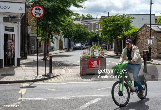 Cyclist passes a low traffic neighbourhood barrier on August 1, 2023 in London, England. Prime Minister Rishi Sunak has called for a review of low...