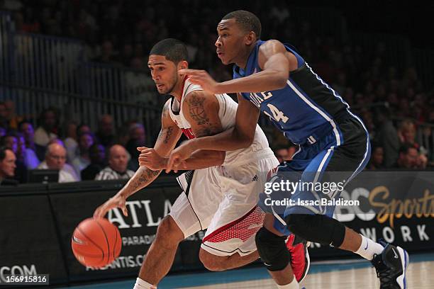 Peyton Siva of the Louisville Cardinals drives against Rasheed Sulaimon of the Duke Blue Devils during the Battle 4 Atlantis tournament at Atlantis...