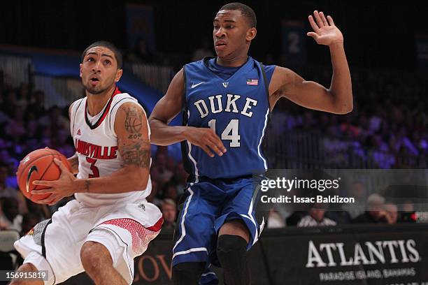 Peyton Siva of the Louisville Cardinals dribbles against Rasheed Sulaimon of the Duke Blue Devils during the Battle 4 Atlantis tournament at Atlantis...