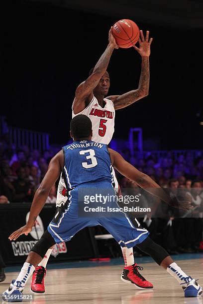 Kevin Ware of the Louisville Cardinals passes against Tyler Thornton of the Duke Blue Devils during the Battle 4 Atlantis tournament at Atlantis...