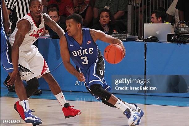 Tyler Thornton of the Duke Blue Devils drives against Russ Smith of the Louisville Cardinals during the Battle 4 Atlantis tournament at Atlantis...