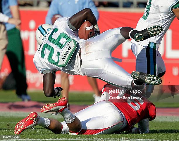 Orleans Darkwa of the Tulane Green Wave is upended by Adrian McDonald of the Houston Cougars at Robertson Stadium on November 24, 2012 in Houston,...