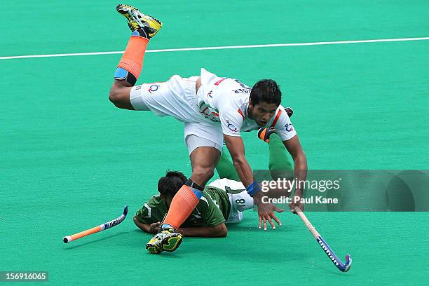 Rupinder Pal Singh of India gets tackled by Muhammad Kashif Ali of Pakistan in the mens bronze medal play off between India and Pakistan during day...