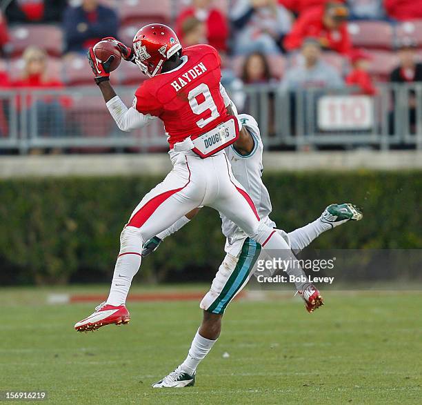 Dewayne Peace of the Houston Cougars completes a pass against the Tulane Green Wave at Robertson Stadium on November 24, 2012 in Houston, Texas....