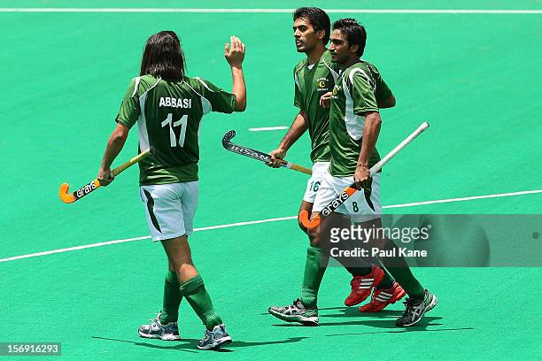 Shakeel Abbasi, Ali Shan and Shafqat Rasool of Pakistan celebrate a goal as Danish Mujtaba of India walks past during day four of the 2012...