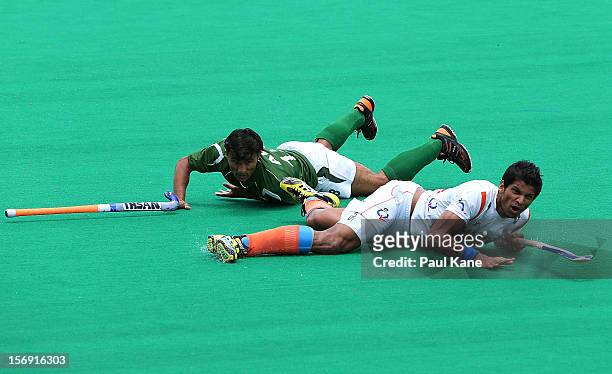 Rupinder Pal Singh of India looks on after being tackled by Muhammad Kashif Ali of Pakistan in the mens bronze medal play off between India and...