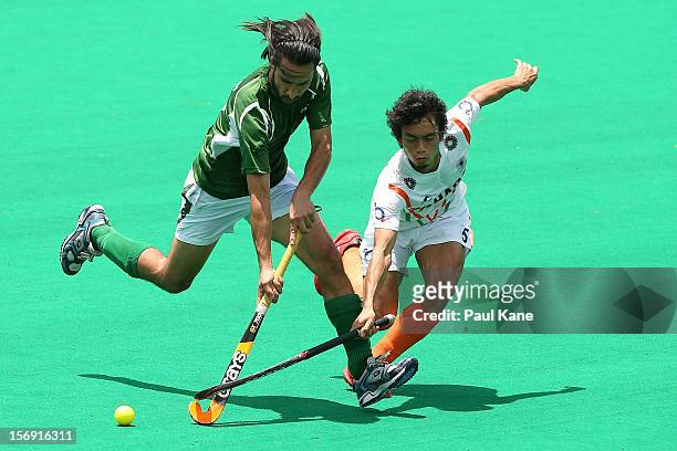 Shakeel Abbasi of Pakistan and Kothajit Singh Khadangbam of India contest for the ball in the bronze medal play off between India and Pakistan during...