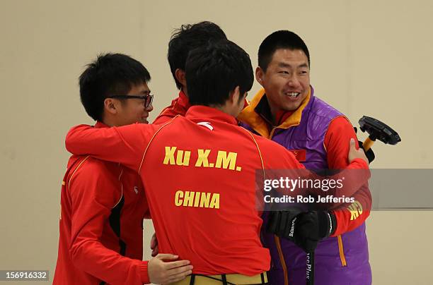 The China team of Rui Liu, Xiaoming Xu, Jialiang Zang and Dexin Ba celebrate beating Japan during the Pacific Asia 2012 Curling Championship at the...