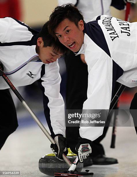 Tsuyoshi Yamaguchi of Japan keeps an eye on the head during the Pacific Asia 2012 Curling Championship at the Naseby Indoor Curling Arena on November...