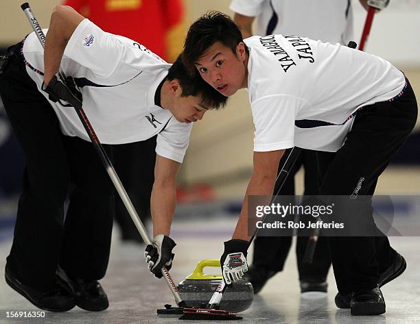 Tsuyoshi Yamaguchi of Japan keeps an eye on the head during the Pacific Asia 2012 Curling Championship at the Naseby Indoor Curling Arena on November...