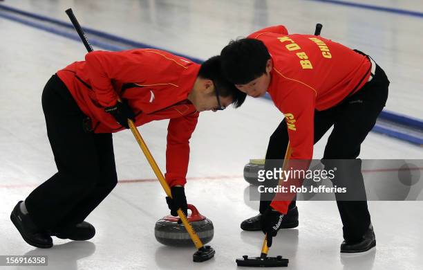 Dexin Ba and Tetsuro Shimizu of China during the Pacific Asia 2012 Curling Championship at the Naseby Indoor Curling Arena on November 25, 2012 in...
