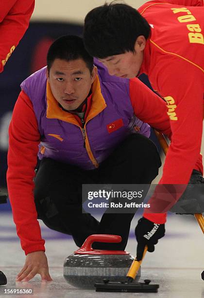 Rui Liu of China keeps an eye on his stone during the Pacific Asia 2012 Curling Championship at the Naseby Indoor Curling Arena on November 25, 2012...