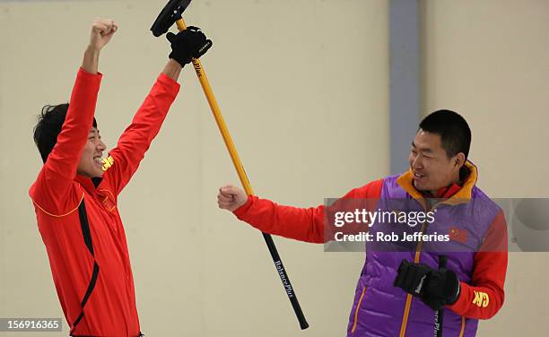 Rui Liu and Dexin Ba of China celebrate their win over Japan during the Pacific Asia 2012 Curling Championship at the Naseby Indoor Curling Arena on...