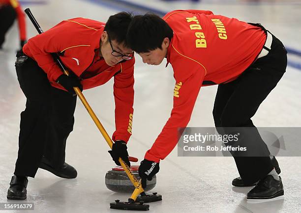 Jialiang Zang and Dexin Ba of China in action during the Pacific Asia 2012 Curling Championship at the Naseby Indoor Curling Arena on November 25,...