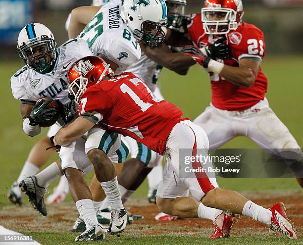 Derrick Strozier of the Tulane Green Wave is hit by Chris Cermin of the Houston Cougars at Robertson Stadium on November 24, 2012 in Houston, Texas....