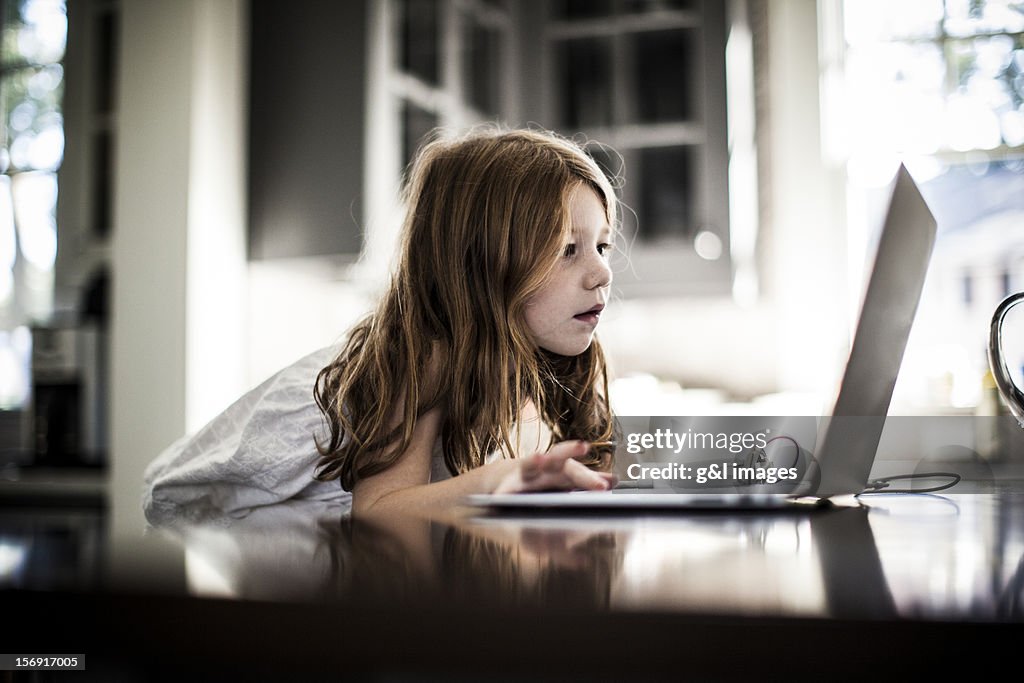 Girl (6yrs) using laptop