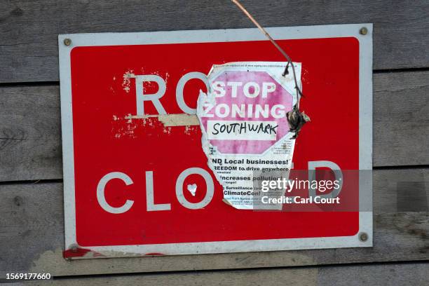 Protest poster is stuck on a planter forming part of a low traffic neighbourhood barrier on August 1, 2023 in London, England. Prime Minister Rishi...