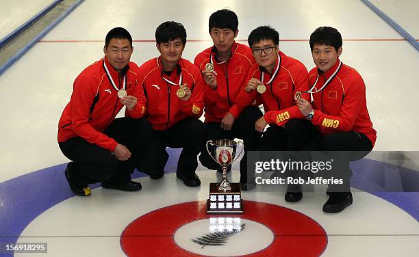 The victorious China team of Rui Liu, Xiaoming Xu, Jialiang Zang, Dexin Ba and Dejia Zou pose for a photo during the Pacific Asia 2012 Curling...