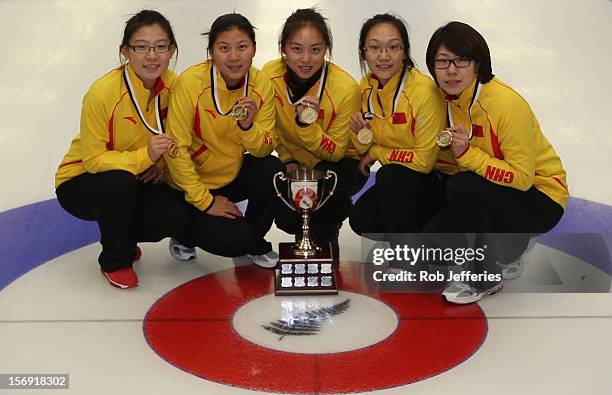 The China team of Bingyu Wang, Yin Liu, Qingshuang Yue, Yan Zhou and Jinli Liu pose for a photo during the Pacific Asia 2012 Curling Championship at...