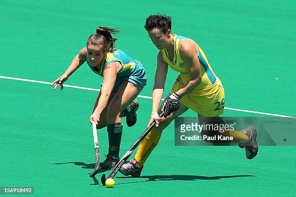 Amelia Spence of the Jillaroos and Teneal Attard of the Hockeyroos contest for the ball in the gold medal match between the Australian Hockeyroos and...