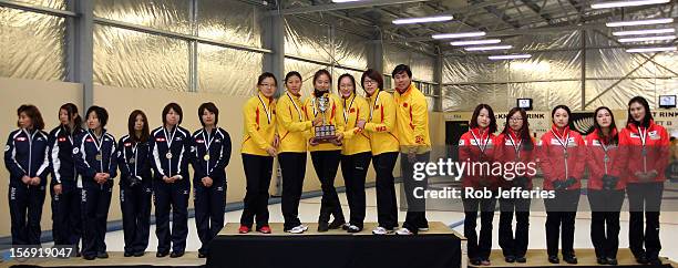 Japan , China and Korea pose for a photo during the Pacific Asia 2012 Curling Championship at the Naseby Indoor Curling Arena on November 25, 2012 in...