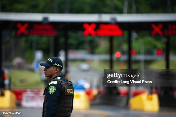 Colombian police officer near the 'El Naranjal' tollbooth at the landslide in Quetame, Cundinamarca, as Colombia now confirms the death of 26 and 3...