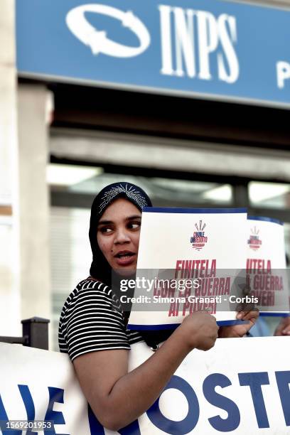 Woman protests in front of the INPS offices with placards reading "End it with the war on the poor", against the government's decision to abolish the...