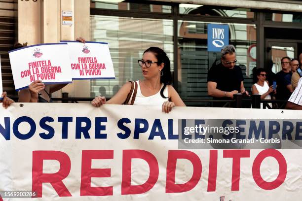 Woman protests in front of the INPS offices with placards reading "End it with the war on the poor", against the government's decision to abolish the...