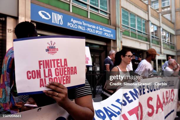 People protesting in front of the INPS offices with placards reading "End it with the war on the poor", against the government's decision to abolish...