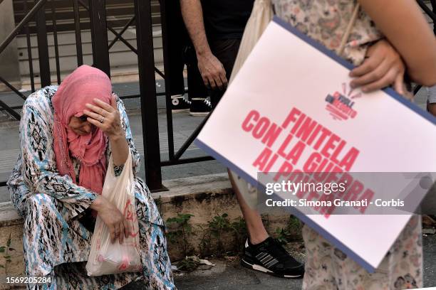 Woman protests in front of the INPS offices with placards reading "End it with the war on the poor", against the government's decision to abolish the...