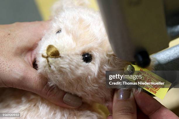 Teddy bear has the company logo pinned to its ear at the Steiff stuffed toy factory on November 23, 2012 in Giengen an der Brenz, Germany. Founded by...