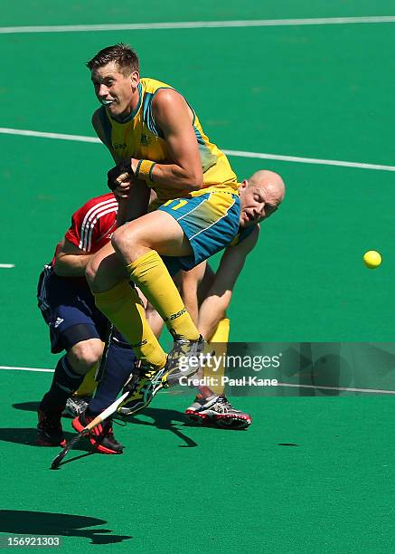 Eddie Ockenden of the Kookaburras jumps clear of a shot on goal by Rob Hammond in the gold medal match between the Australian Kookaburras and England...