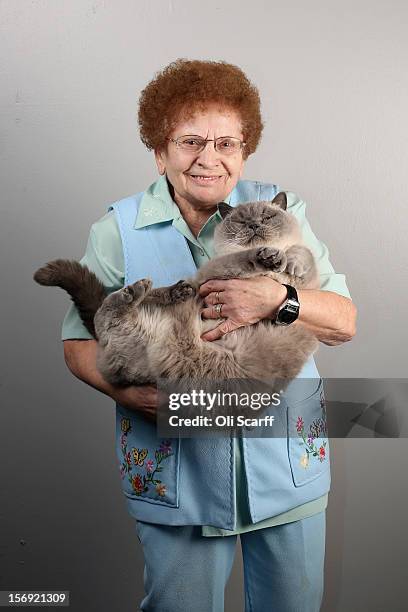 Rosa Wardle poses for a photograph with her cat named 'Blue Snowman' after being exhibited at the Governing Council of the Cat Fancy's 'Supreme...