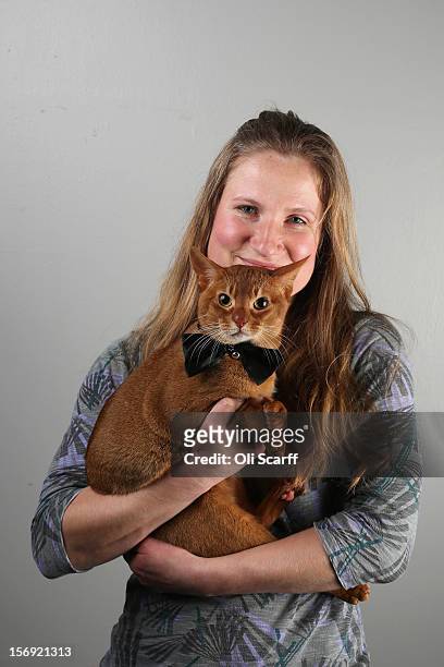 Leanne Dawson poses for a photograph with her Abyssinian cat named 'Strangewaytotell' after being exhibited at the Governing Council of the Cat...