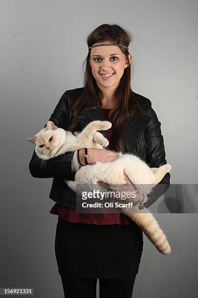 Emily Zand poses for a photograph with her British Colourpointed kitten named 'Mawbritz By Design' after being exhibited at the Governing Council of...