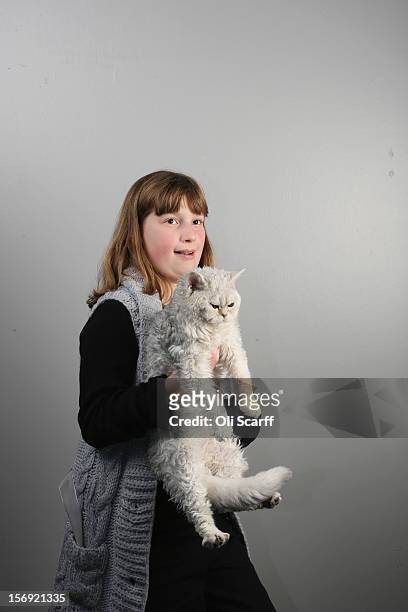 Rose Derbyshire poses for a photograph with her Selkirk Rex kitten named 'Curly Wirly' after being exhibited at the Governing Council of the Cat...