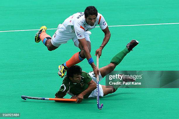 Rupinder Pal Singh of India gets tackled by Muhammad Kashif Ali of Pakistan in the mens bronze medal play off between India and Pakistan during day...