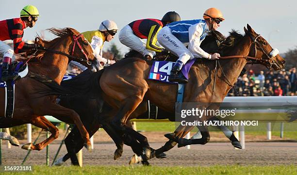 French jockey Olivier Peslier rides on Slemia, the winner of the Prix de l'Arc de Triomphe, during the 2,400-metre Japan Cup horse race at the Tokyo...