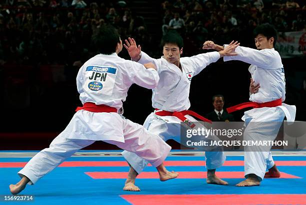 Japanese team members, Takumi Sugino , Takato Soma and Koji Arimoto, compete on November 25, 2012 in the men's team kata event of the Karate world...