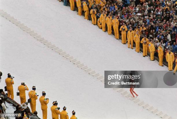 Austrian Olympic luger Josef Feistmantl carrying the Olympic torch up steps at the Bergiselschanze during the opening ceremony of the XII Olympic...