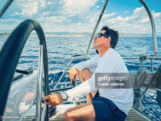 skipper sailing on sailboat - captain yacht stock pictures, royalty-free photos & images